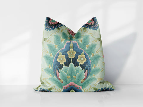 a decorative pillow is sitting on a white surface