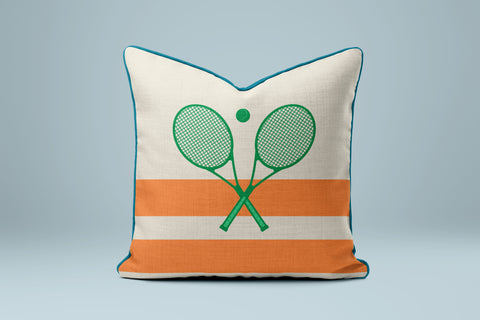 A white and orange throw pillow with a tennis racket design on it.