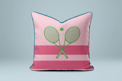 A pink and green striped pillow with a tennis racket design on it.
