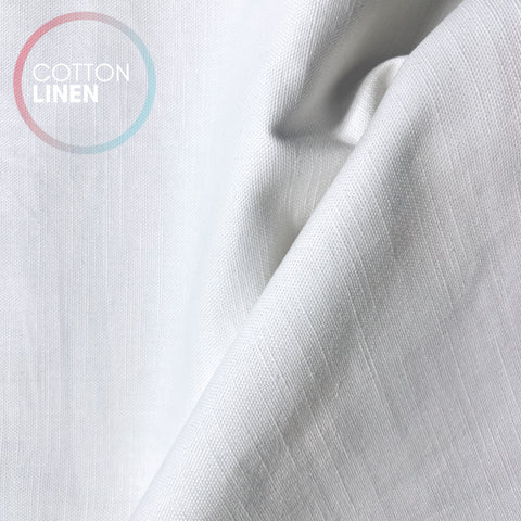 a close-up view of a white fabric, possibly cotton linen, with a textured and wrinkled appearance.