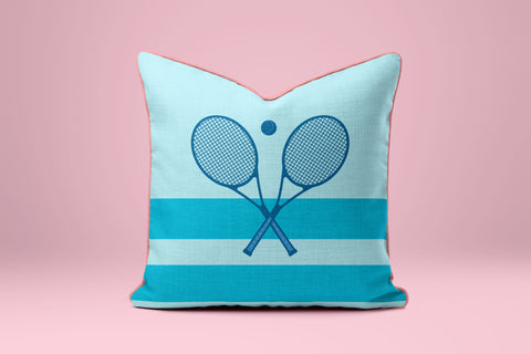 A light blue and white striped pillow with a graphic of two tennis rackets crossed in an X shape.