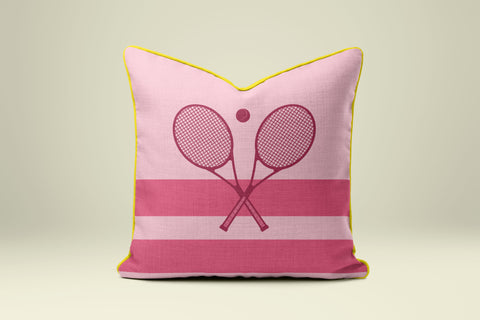 A pink and yellow throw pillow with a tennis racket design on it.