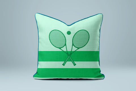 A green and white striped pillow with a graphic of two crossed tennis rackets.