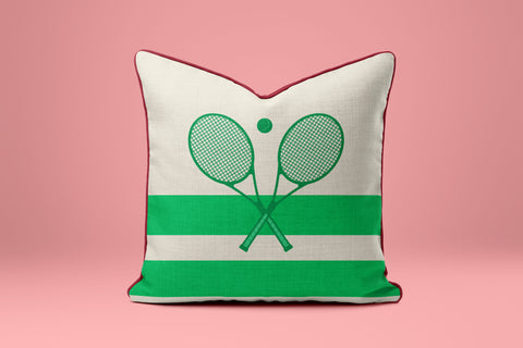 A white and green striped pillow with a graphic of two crossed tennis rackets.