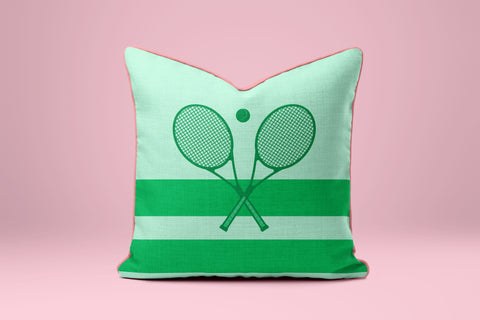 A green and white striped pillow with a graphic of two crossed tennis rackets.