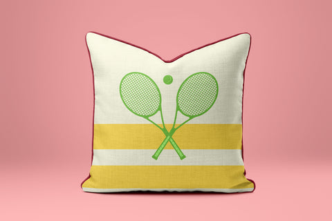 A white and yellow striped pillow with a graphic of two crossed tennis rackets.