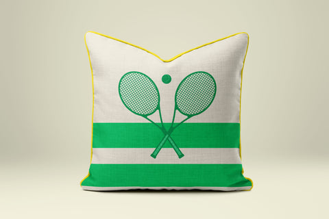 A white and green pillow with a tennis racket design on it.