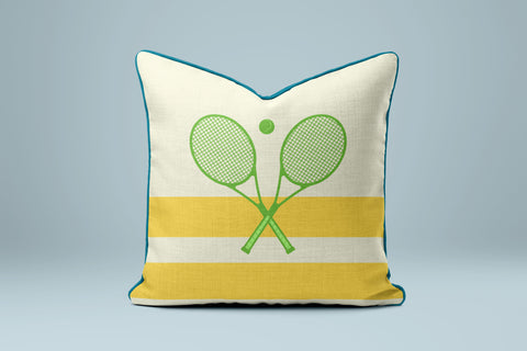 A yellow and white throw pillow with a graphic of two crossed tennis rackets.
