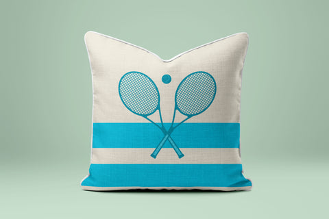 A white and blue striped pillow with a graphic of two crossed tennis rackets.
