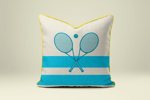 A white and blue striped pillow with a graphic of two crossed tennis rackets.