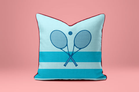 A blue and white striped pillow with a graphic of two crossed tennis rackets.