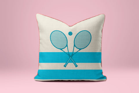 A white and blue striped pillow with a graphic of two crossed tennis rackets.